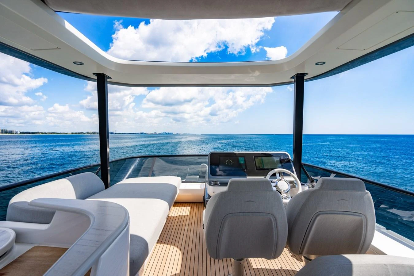The helm area offers a panoramic view of the open sea, complemented by luxurious seating and modern controls. aboard EFFORTLESS Yacht for Sale