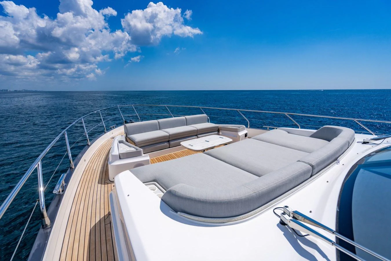 The yacht's foredeck features luxurious sun pads and ample seating, perfect for relaxation under the open sky. aboard EFFORTLESS Yacht for Sale