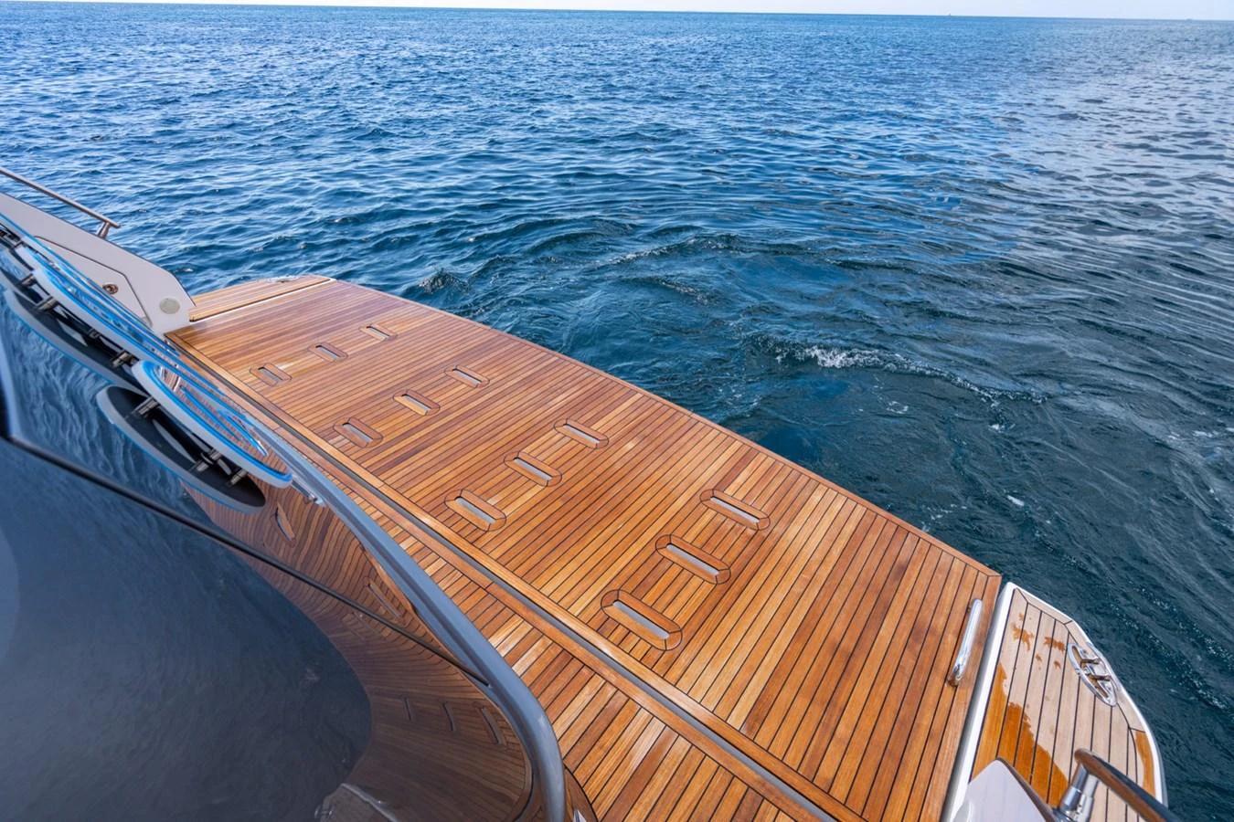The yacht's elegant teak swim platform offers easy access to the water. aboard EFFORTLESS Yacht for Sale