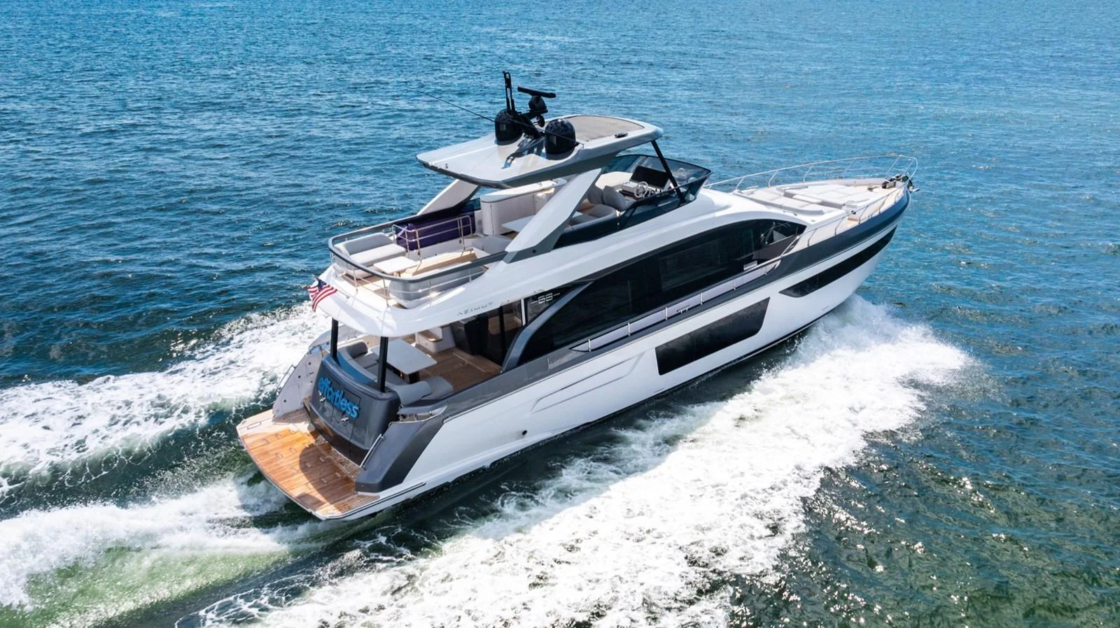 A sleek and modern yacht cruises swiftly on the open water, showcasing its elegant design and spacious decks. aboard EFFORTLESS Yacht for Sale