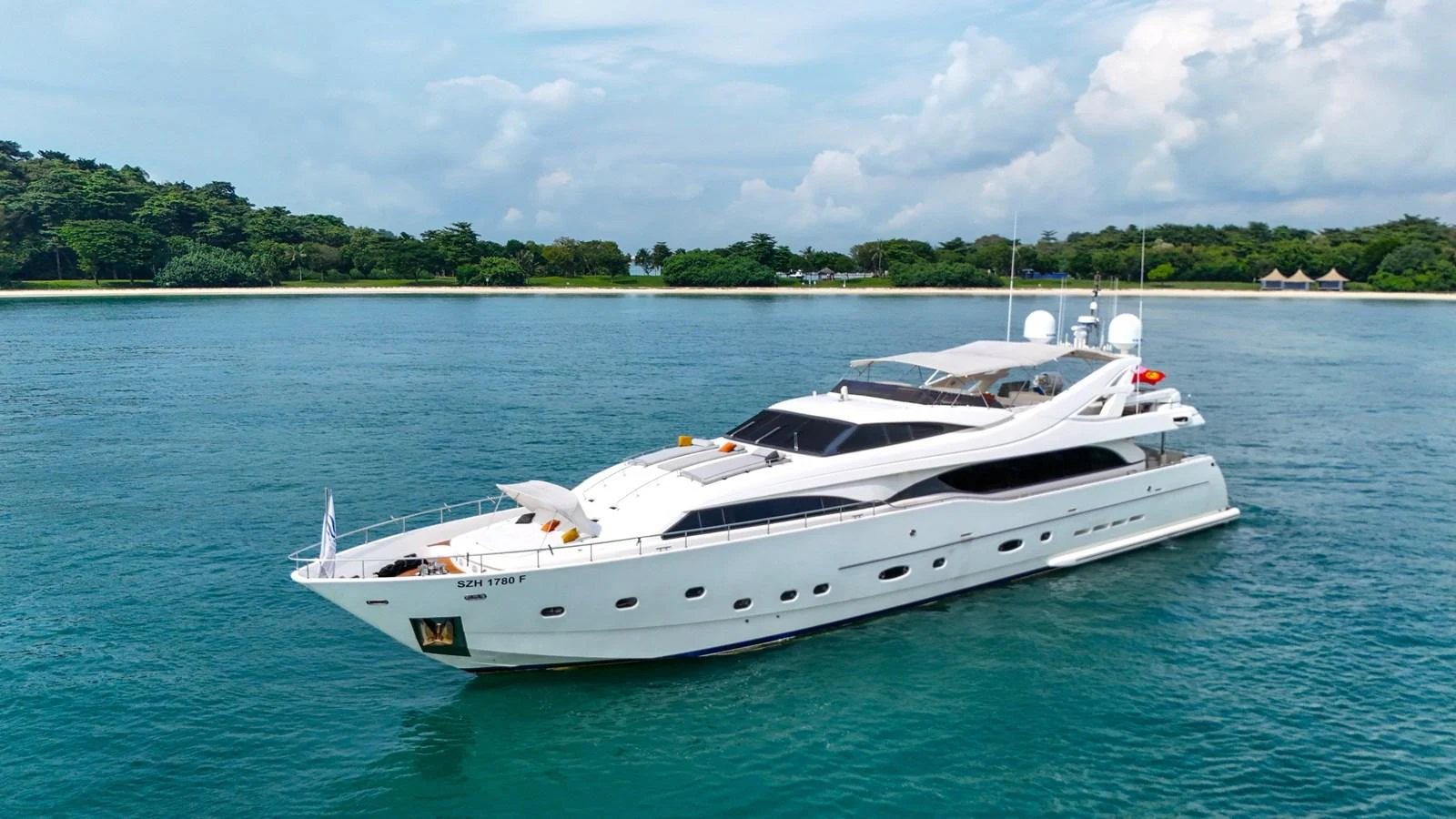 A sleek, luxurious yacht glides gracefully on calm waters with a scenic backdrop. aboard CUSTOM LINE 112 Yacht for Sale