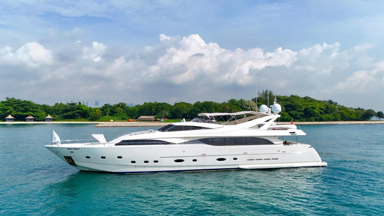 A sleek and modern yacht cruises gracefully on calm waters under a clear sky. aboard CUSTOM LINE 112 Yacht for Sale