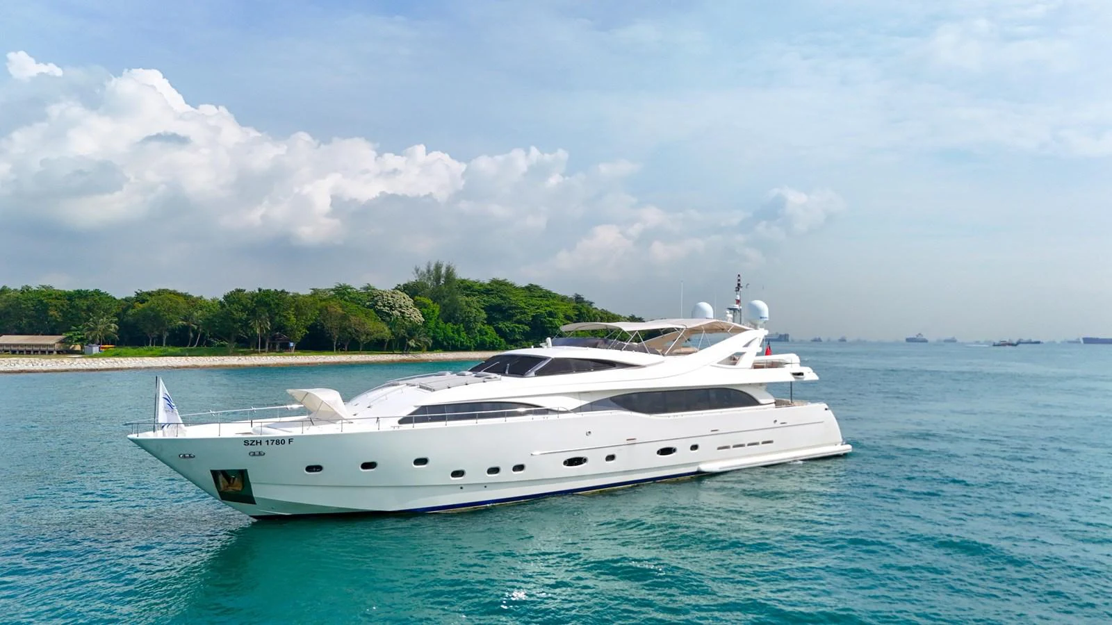 A sleek and modern yacht cruising on calm waters under a partly cloudy sky. aboard CUSTOM LINE 112 Yacht for Sale