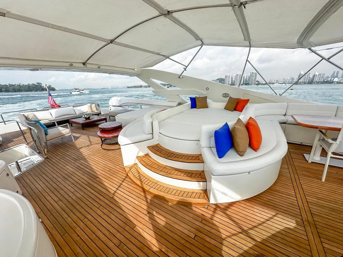 The flybridge offers a spacious and inviting area with comfortable seating and scenic views. aboard CUSTOM LINE 112 Yacht for Sale