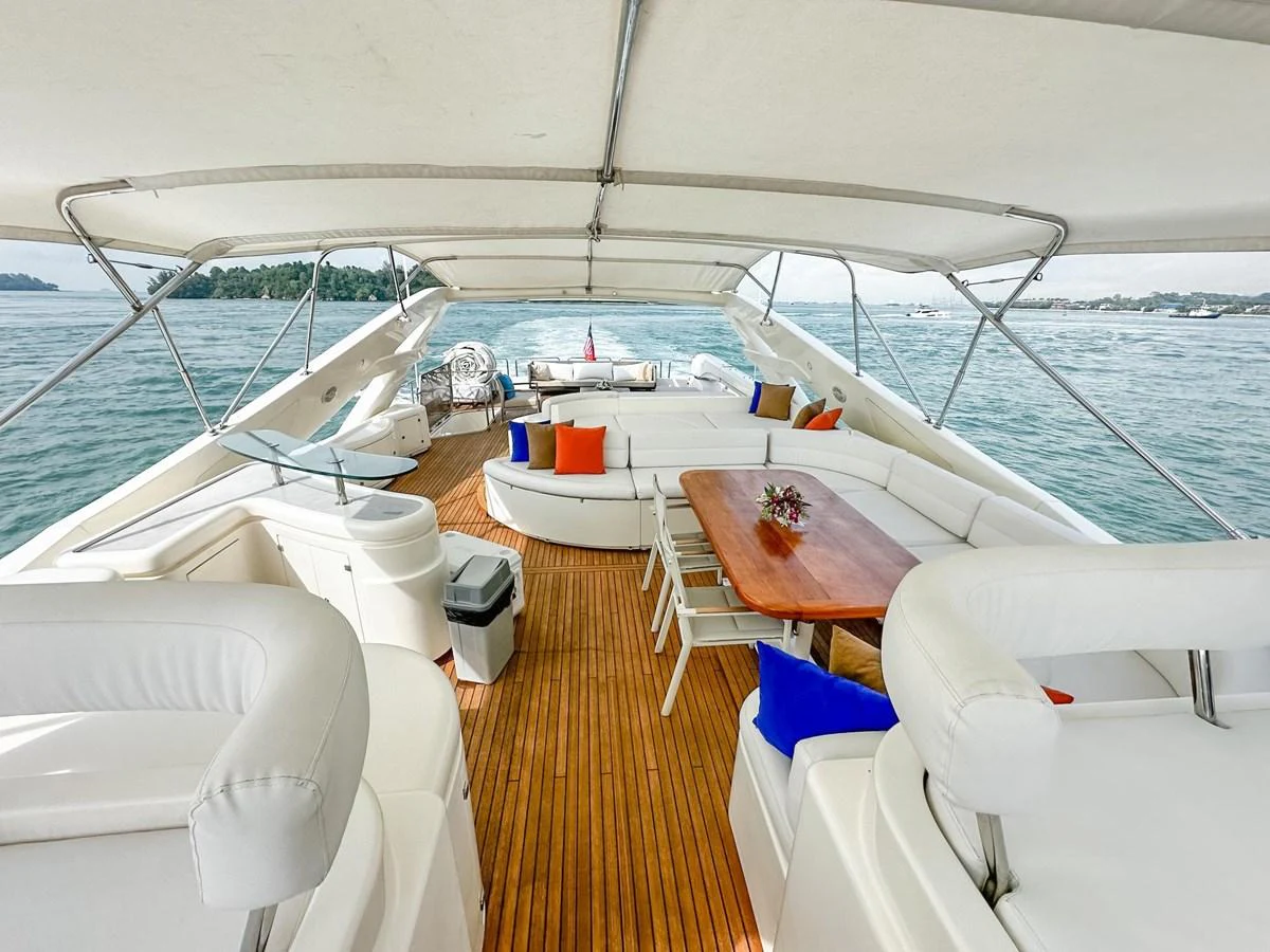 The flybridge offers a spacious and inviting area with comfortable seating and a dining table, perfect for enjoying the open sea views. aboard CUSTOM LINE 112 Yacht for Sale