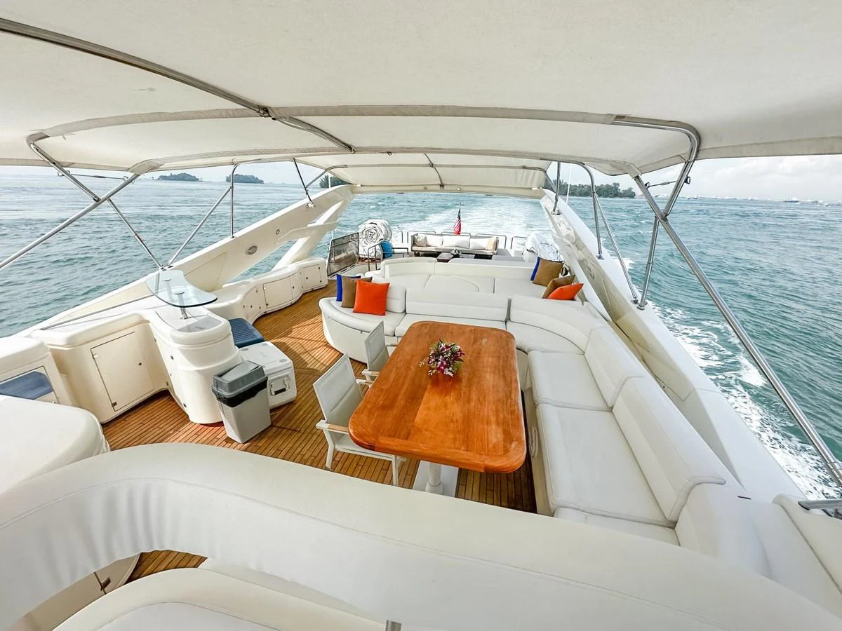 The flybridge offers a spacious and luxurious outdoor seating area with a dining table and panoramic views. aboard CUSTOM LINE 112 Yacht for Sale