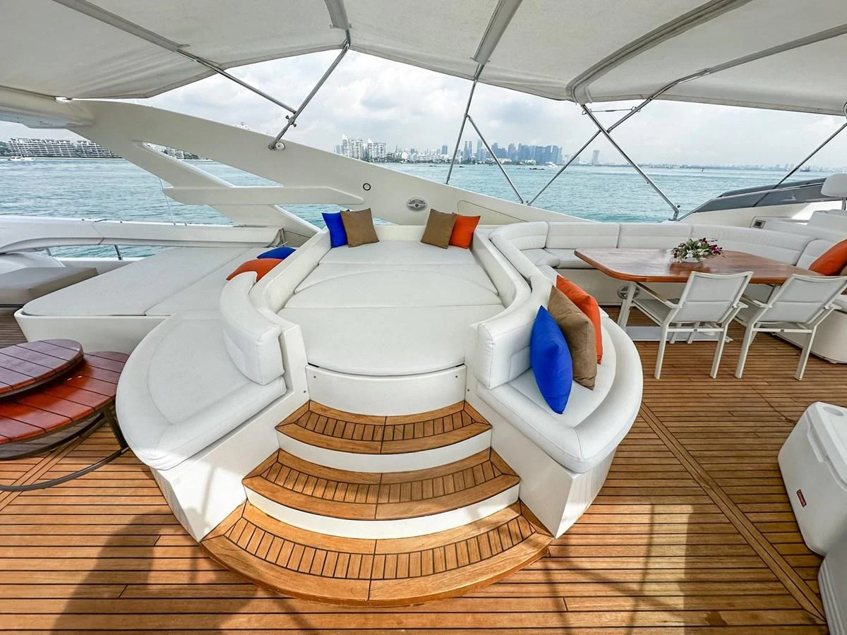 The sundeck features a luxurious circular seating area with plush cushions and a dining table, perfect for relaxation and socializing. aboard CUSTOM LINE 112 Yacht for Sale