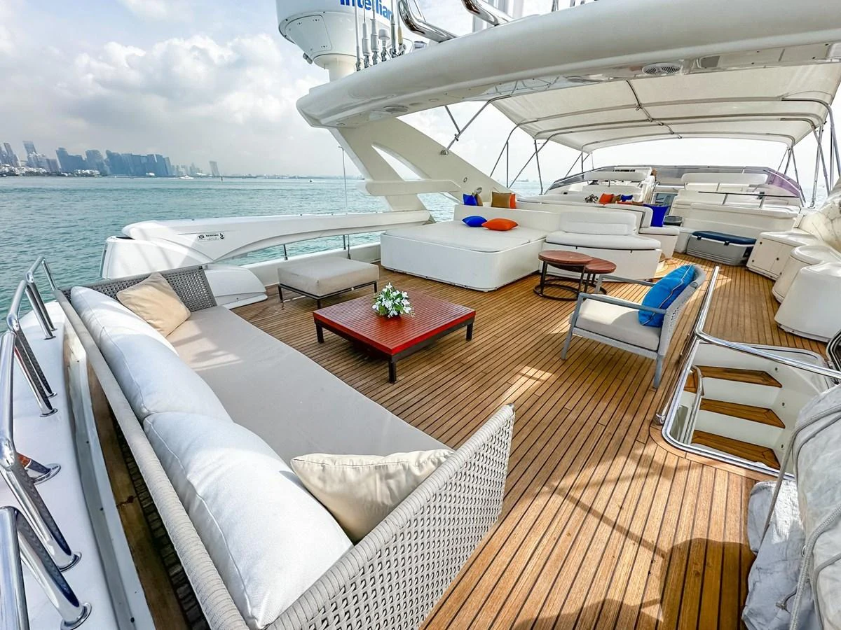 The flybridge offers a spacious and luxurious outdoor lounging area with ample seating and stunning views. aboard CUSTOM LINE 112 Yacht for Sale
