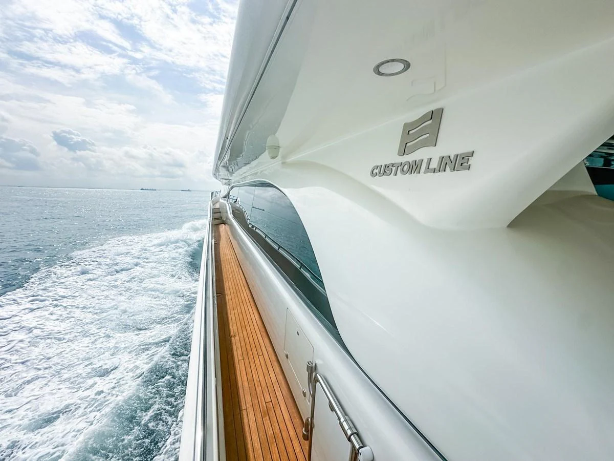 The sleek exterior of the yacht glides effortlessly through the water, showcasing its modern design and luxurious finish. aboard CUSTOM LINE 112 Yacht for Sale