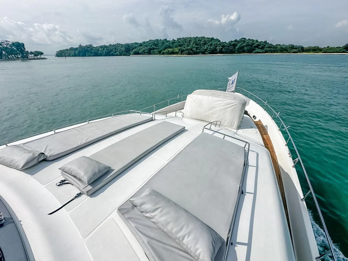 The yacht's foredeck features spacious sun pads with a serene view of the surrounding waters. aboard CUSTOM LINE 112 Yacht for Sale