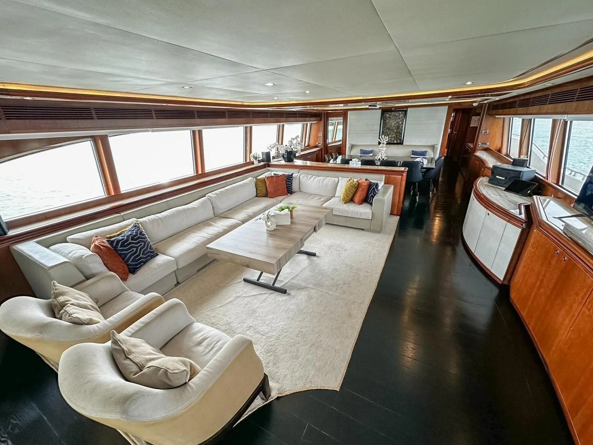 The salon features a spacious seating area with plush furnishings and elegant decor. aboard CUSTOM LINE 112 Yacht for Sale