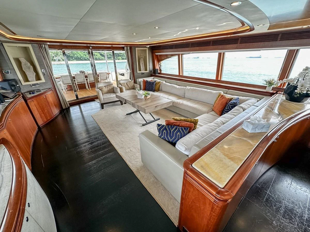 The salon features a spacious seating area with panoramic windows offering stunning ocean views. aboard CUSTOM LINE 112 Yacht for Sale