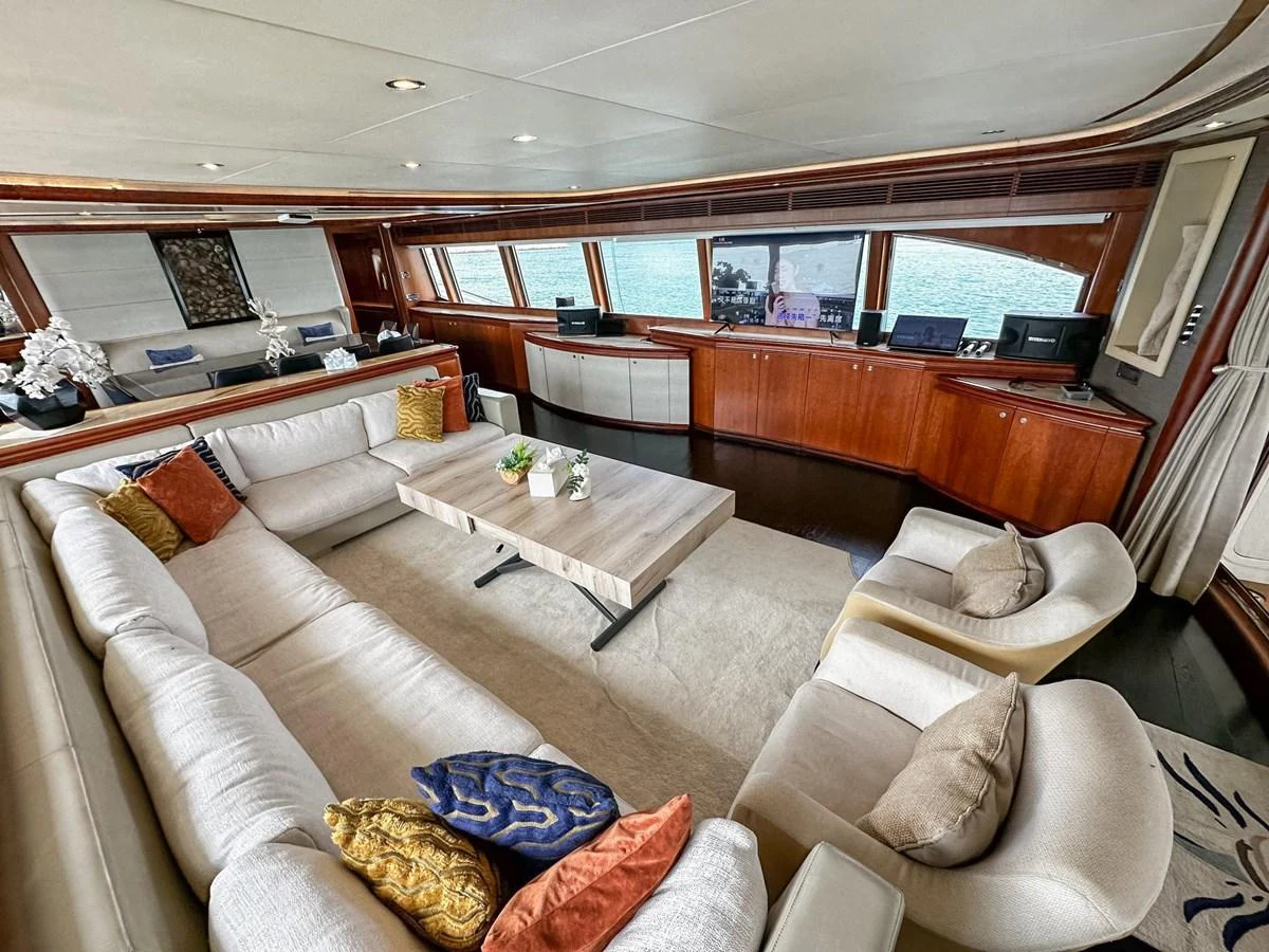 The salon features a spacious seating area with plush sofas and elegant decor, offering panoramic views through large windows. aboard CUSTOM LINE 112 Yacht for Sale