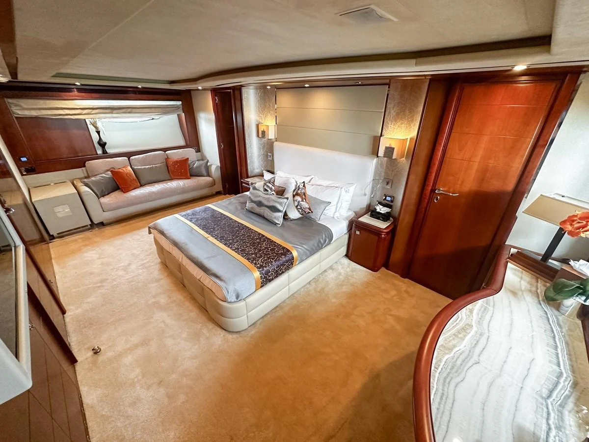 The master stateroom features a luxurious bed, elegant decor, and ample natural light. aboard CUSTOM LINE 112 Yacht for Sale