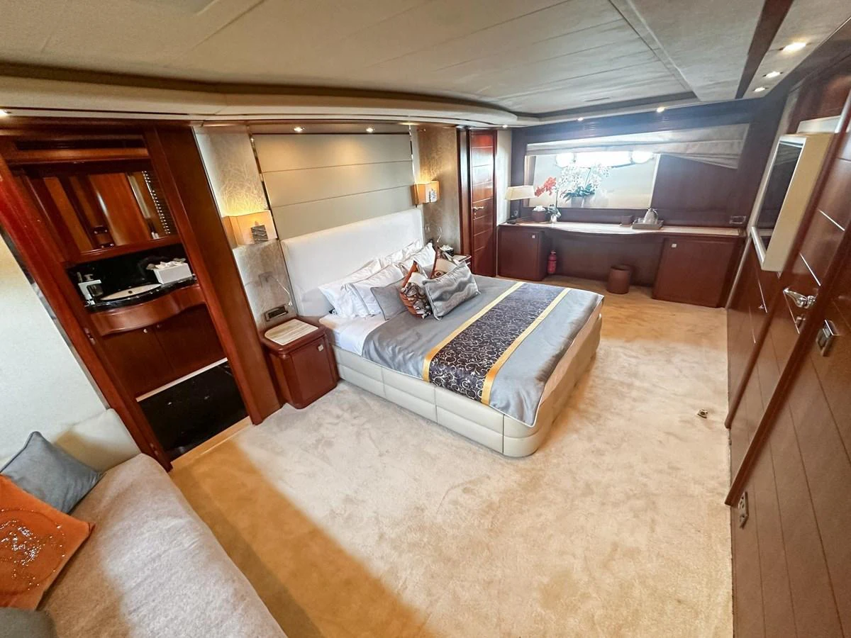The master stateroom features a luxurious bed, ample storage, and elegant decor. aboard CUSTOM LINE 112 Yacht for Sale
