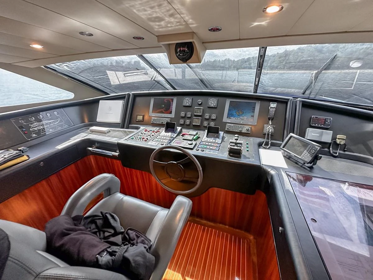 The helm of this yacht features a sophisticated control panel with a panoramic view through large windows. aboard CUSTOM LINE 112 Yacht for Sale