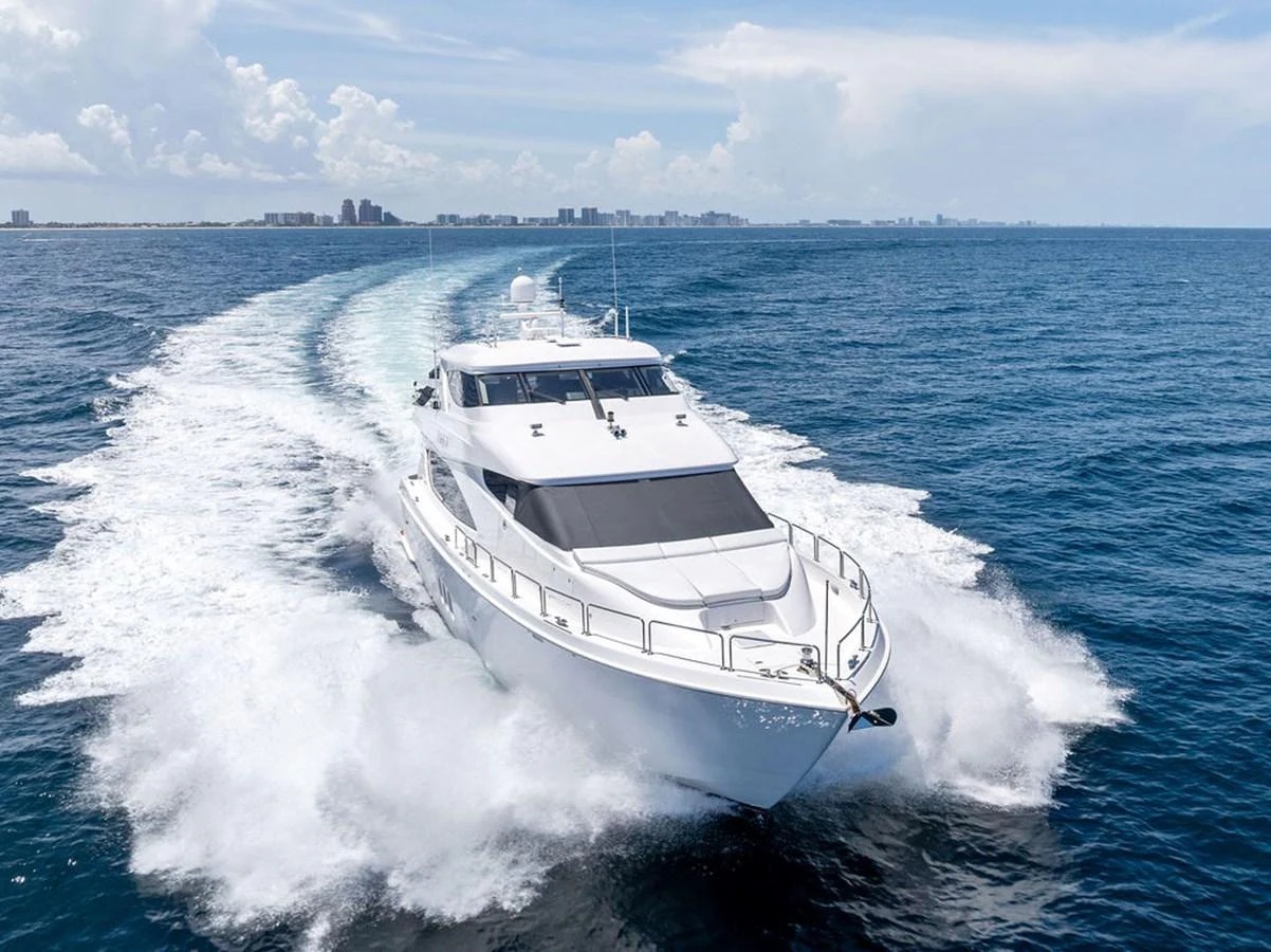 A sleek white yacht cruises swiftly through the open sea, leaving a trail of frothy waves behind. aboard GRIFFIN Yacht for Sale