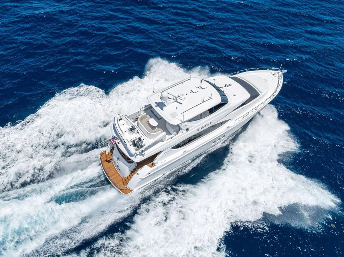 A luxurious yacht cruises swiftly through the open sea, showcasing its sleek design and powerful performance. aboard GRIFFIN Yacht for Sale