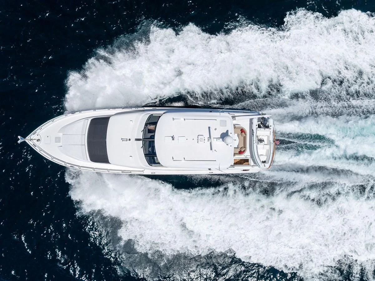 A sleek yacht cruises swiftly through the water, leaving a trail of white foam behind. aboard GRIFFIN Yacht for Sale