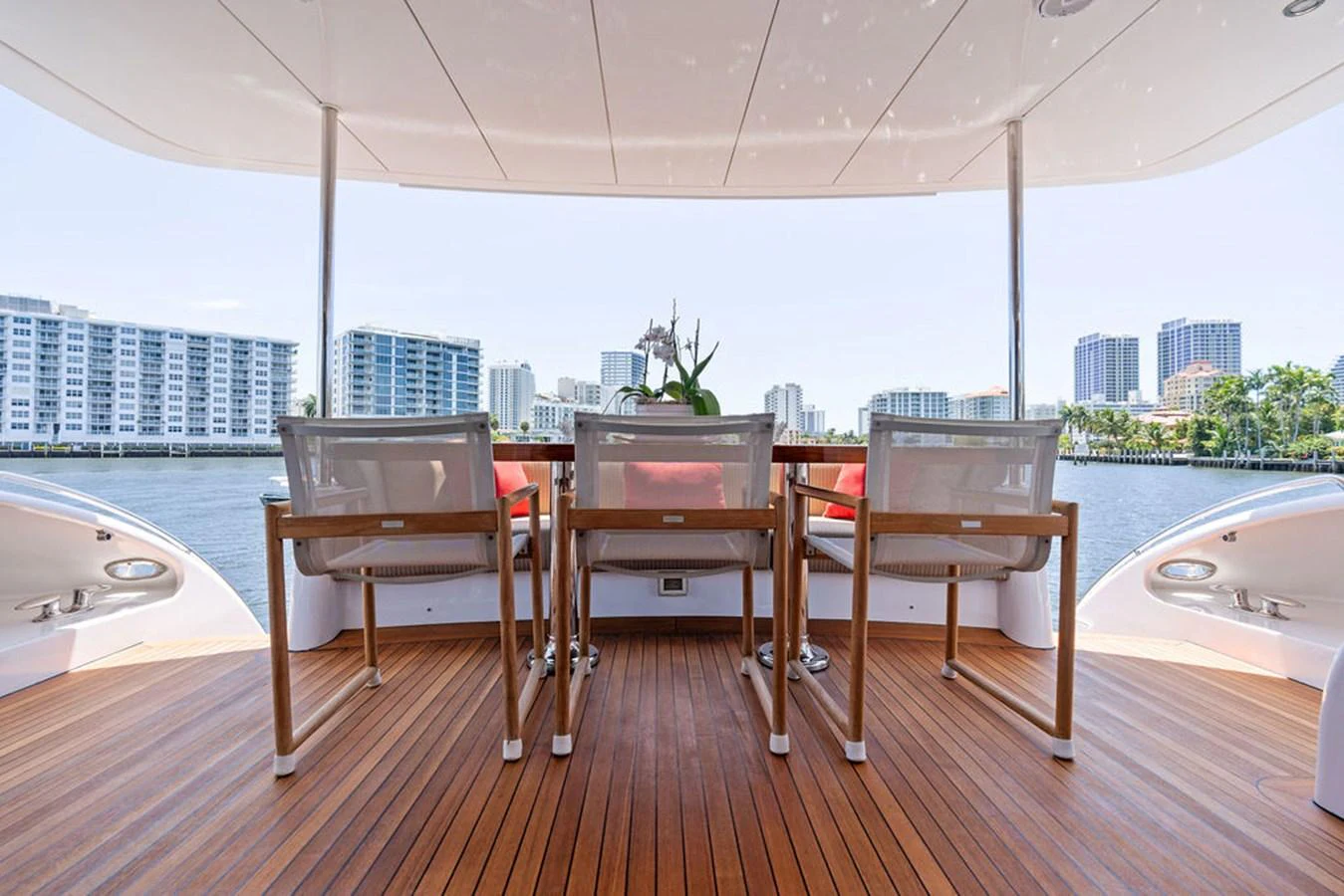 The aft deck features a stylish dining area with a beautiful waterfront view. aboard GRIFFIN Yacht for Sale