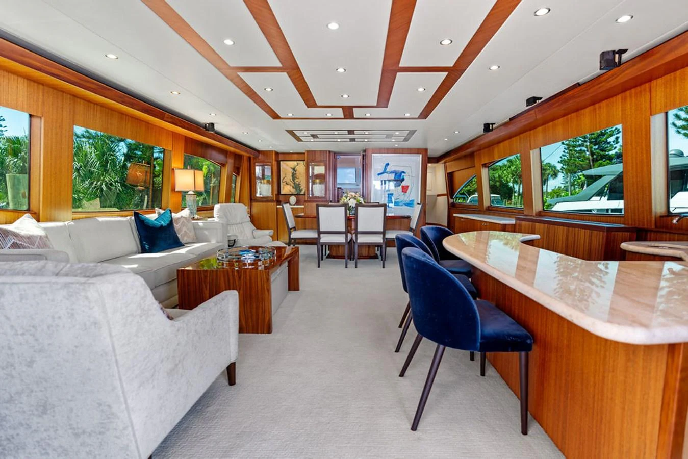 The yacht's salon features elegant seating, a dining area, and large windows offering scenic views. aboard GRIFFIN Yacht for Sale