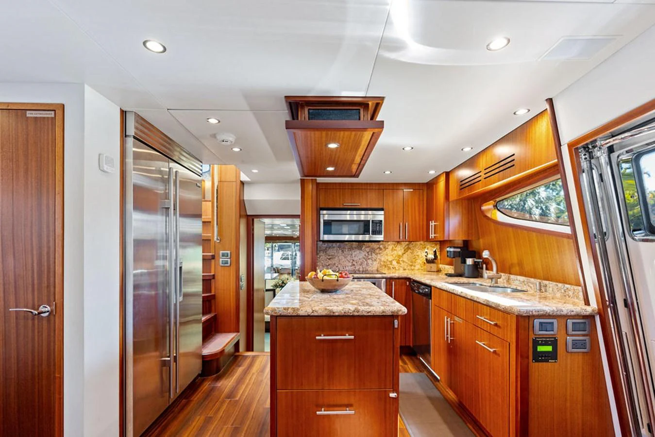 The galley features modern appliances and elegant wooden cabinetry, creating a warm and inviting space for culinary endeavors. aboard GRIFFIN Yacht for Sale