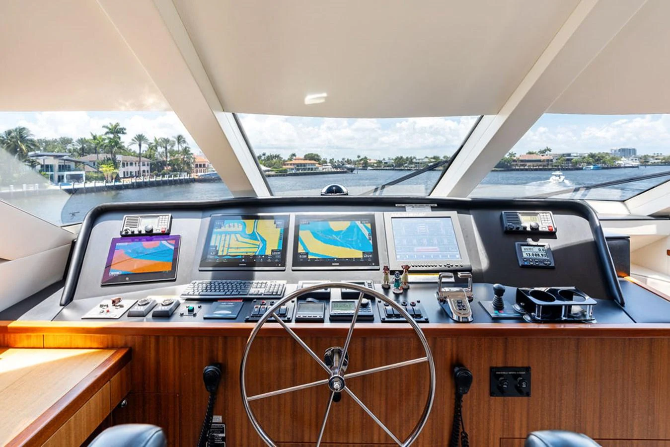 The helm station offers a panoramic view with advanced navigation equipment and a sleek steering wheel. aboard GRIFFIN Yacht for Sale