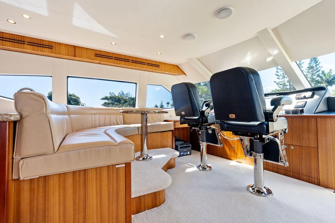 The yacht's helm area features luxurious seating and a spacious, well-lit environment. aboard GRIFFIN Yacht for Sale