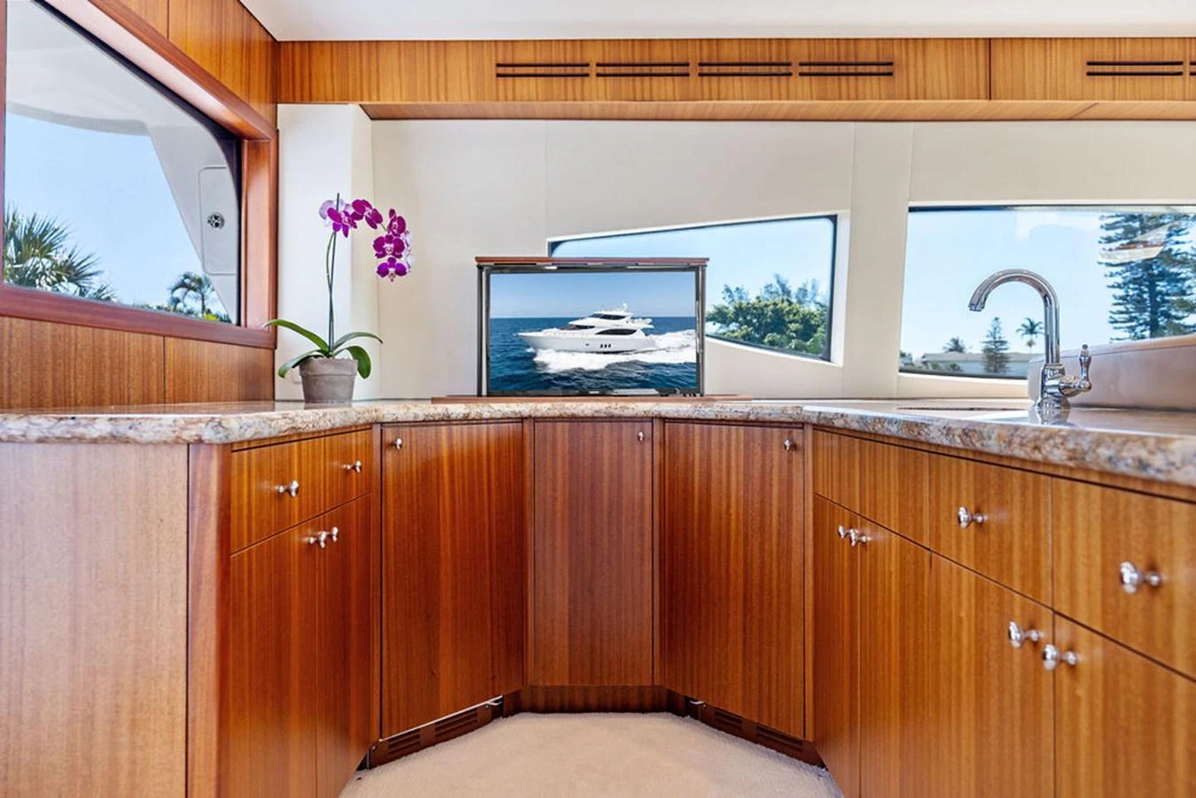 The yacht's galley features elegant wooden cabinetry and modern appliances, creating a warm and functional space. aboard GRIFFIN Yacht for Sale
