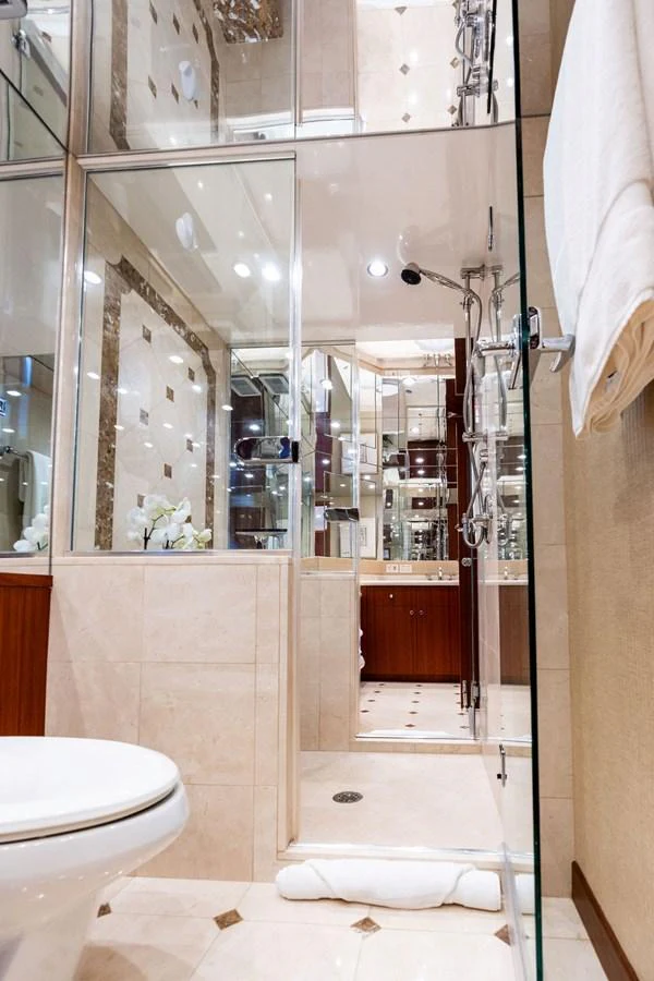 The yacht's bathroom features elegant fixtures and a luxurious design with ample mirrors and glass accents. aboard GRIFFIN Yacht for Sale