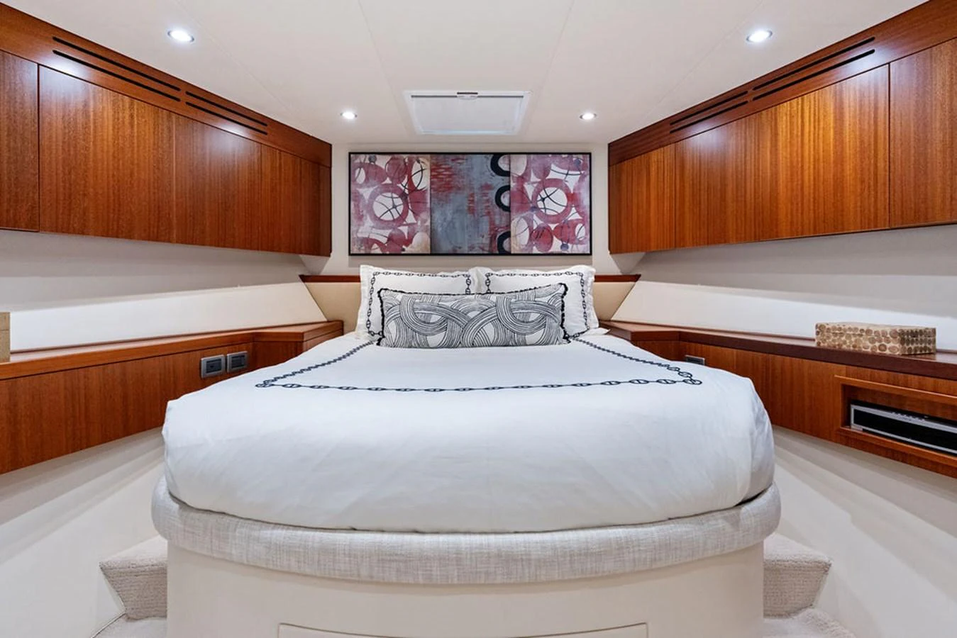 The stateroom features a luxurious bed with elegant wood cabinetry and modern decor. aboard GRIFFIN Yacht for Sale