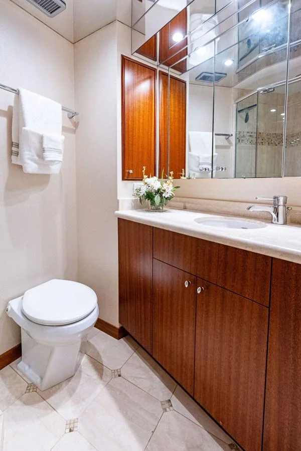 The yacht's bathroom features elegant wood cabinetry and a modern sink area. aboard GRIFFIN Yacht for Sale