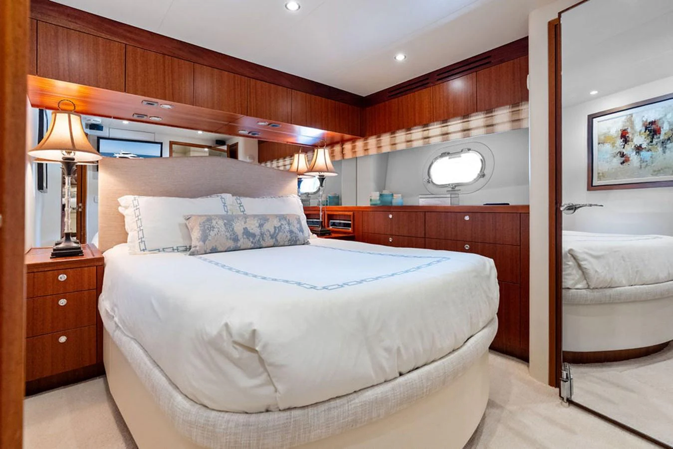 A luxurious stateroom featuring a comfortable bed, elegant wood finishes, and ambient lighting. aboard GRIFFIN Yacht for Sale