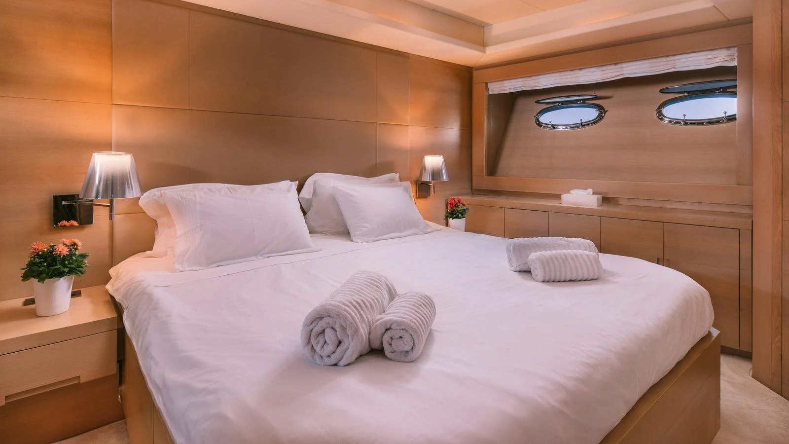 The stateroom features a plush bed with elegant linens and warm wooden accents, creating a cozy and inviting atmosphere. aboard THIS IS MINE Yacht for Sale