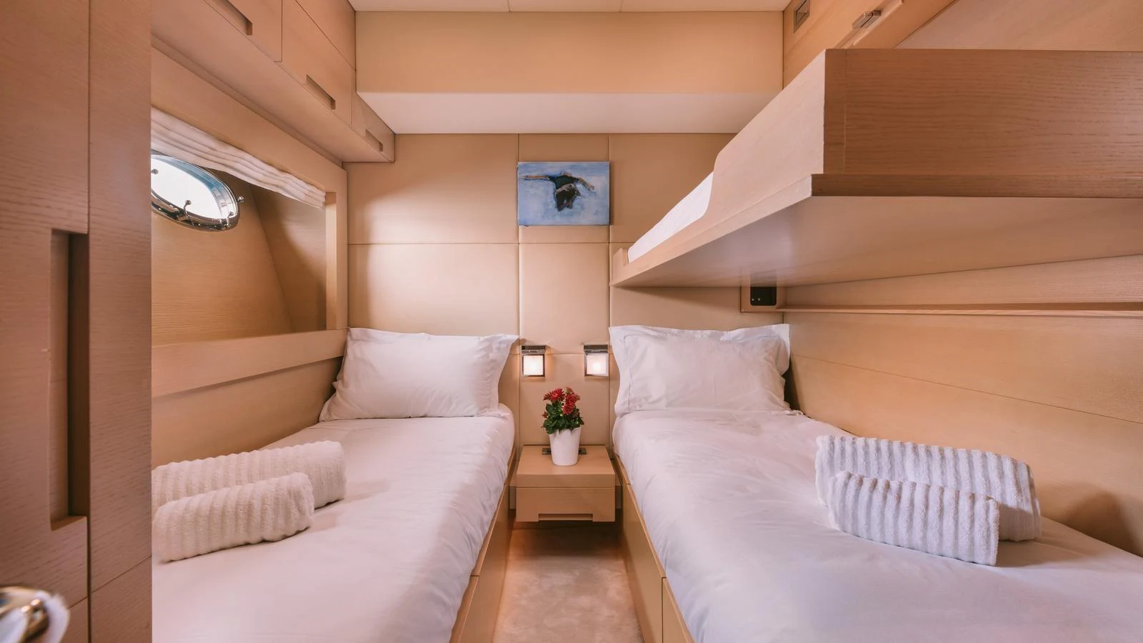 The twin stateroom offers a cozy and inviting space with two single beds and soft lighting. aboard THIS IS MINE Yacht for Sale