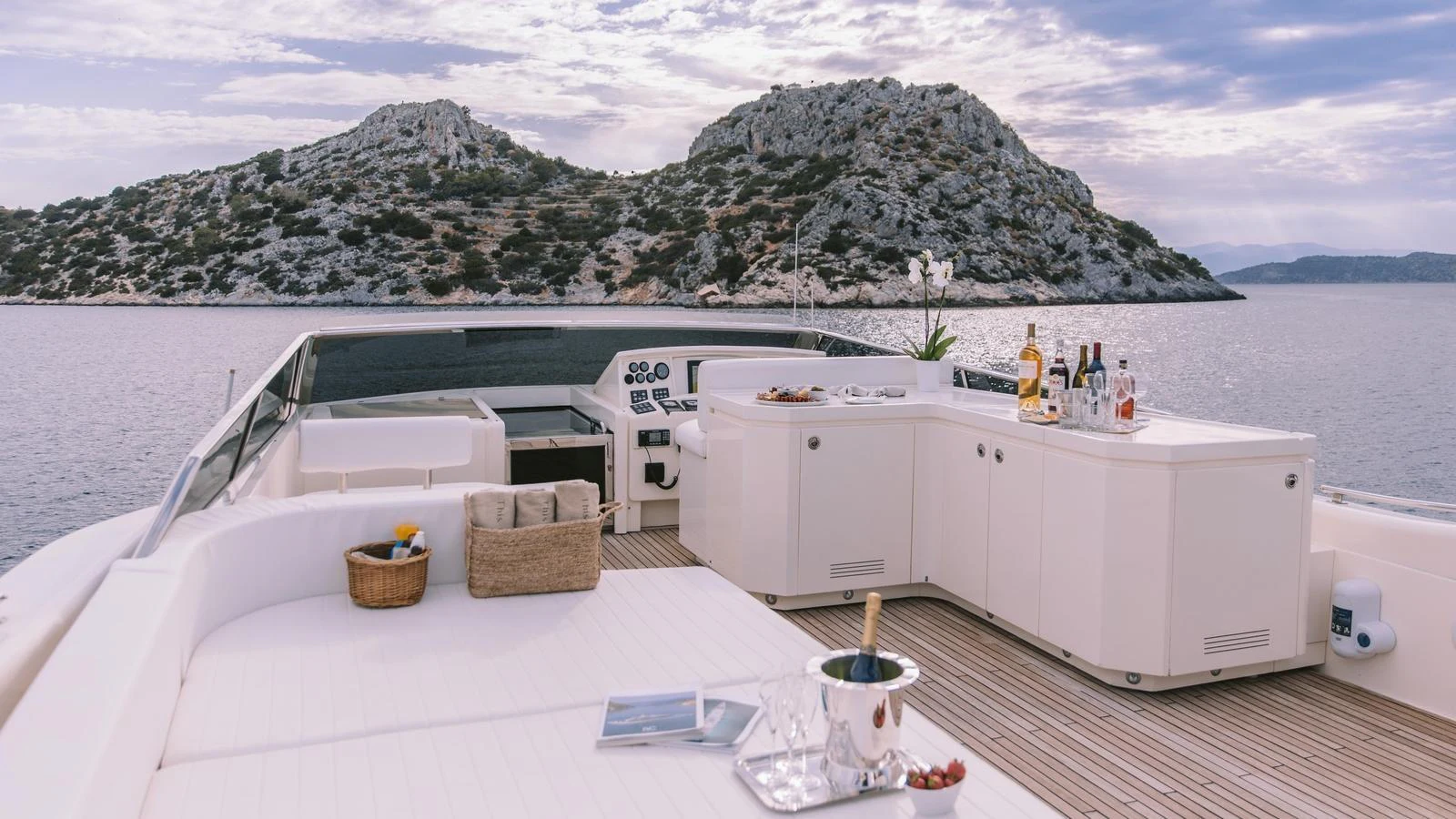 The flybridge offers a luxurious open-air space with a bar and lounging area, perfect for relaxation and entertainment. aboard THIS IS MINE Yacht for Sale