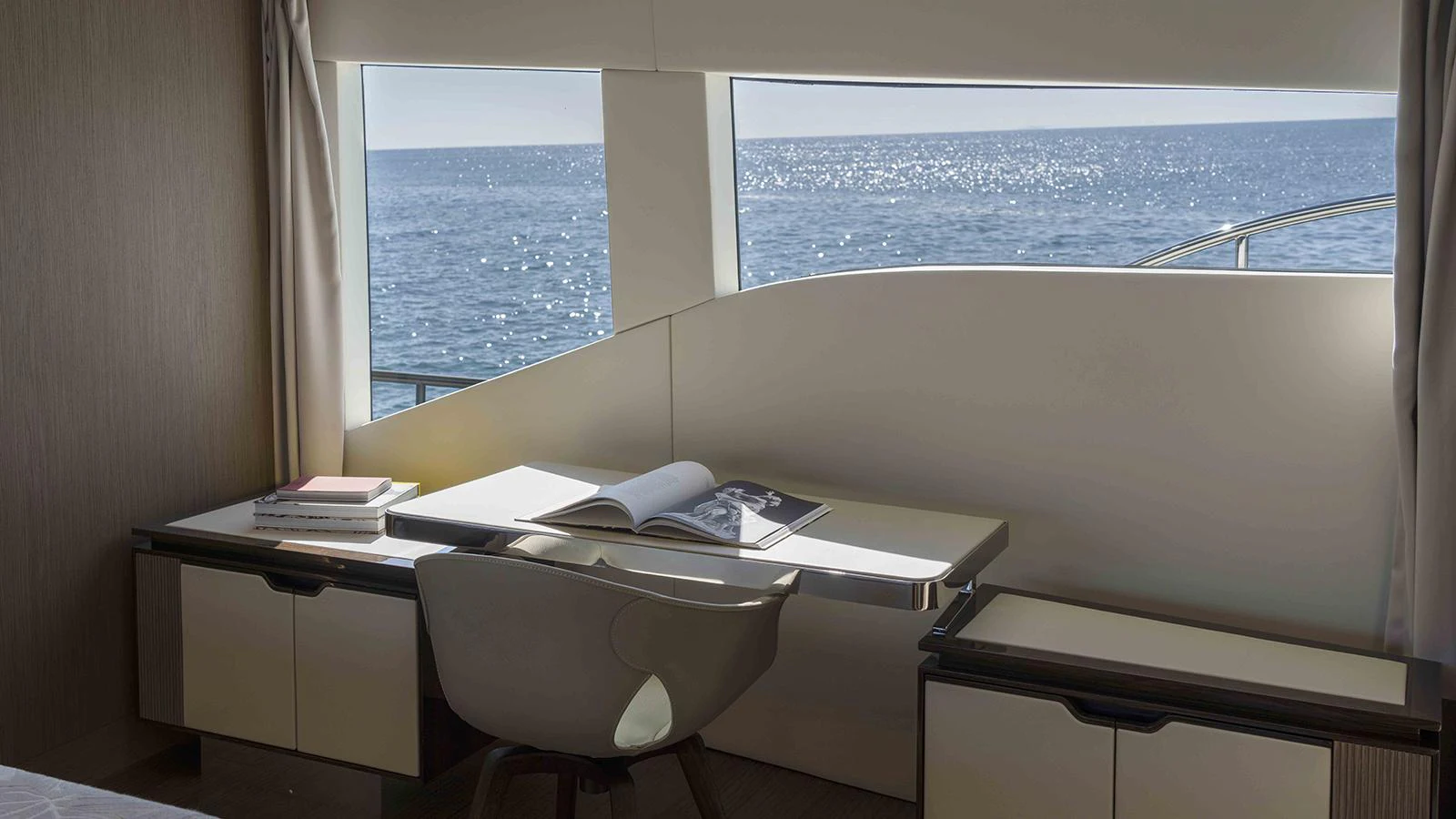 a desk with a chair and a window aboard FOUR JOYS Yacht for Sale