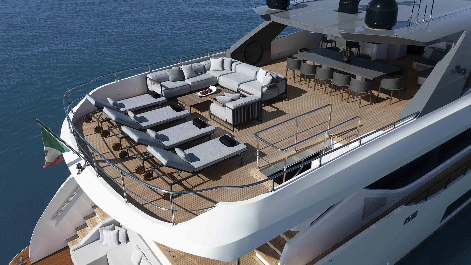 a large white ship with a deck and chairs on it aboard FOUR JOYS Yacht for Sale