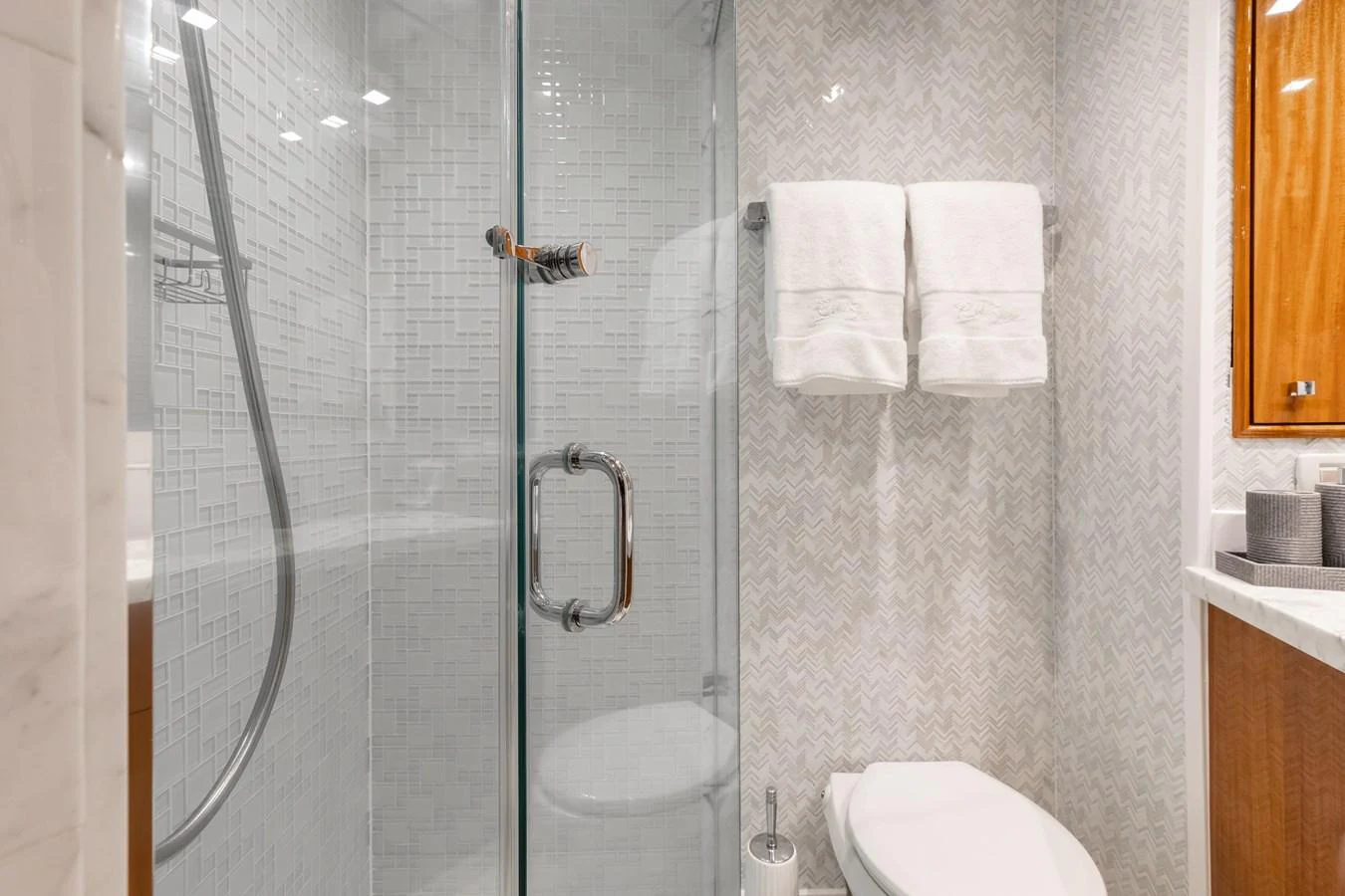 The yacht's bathroom features a sleek glass shower and modern fixtures. aboard RITZ SEA Yacht for Sale