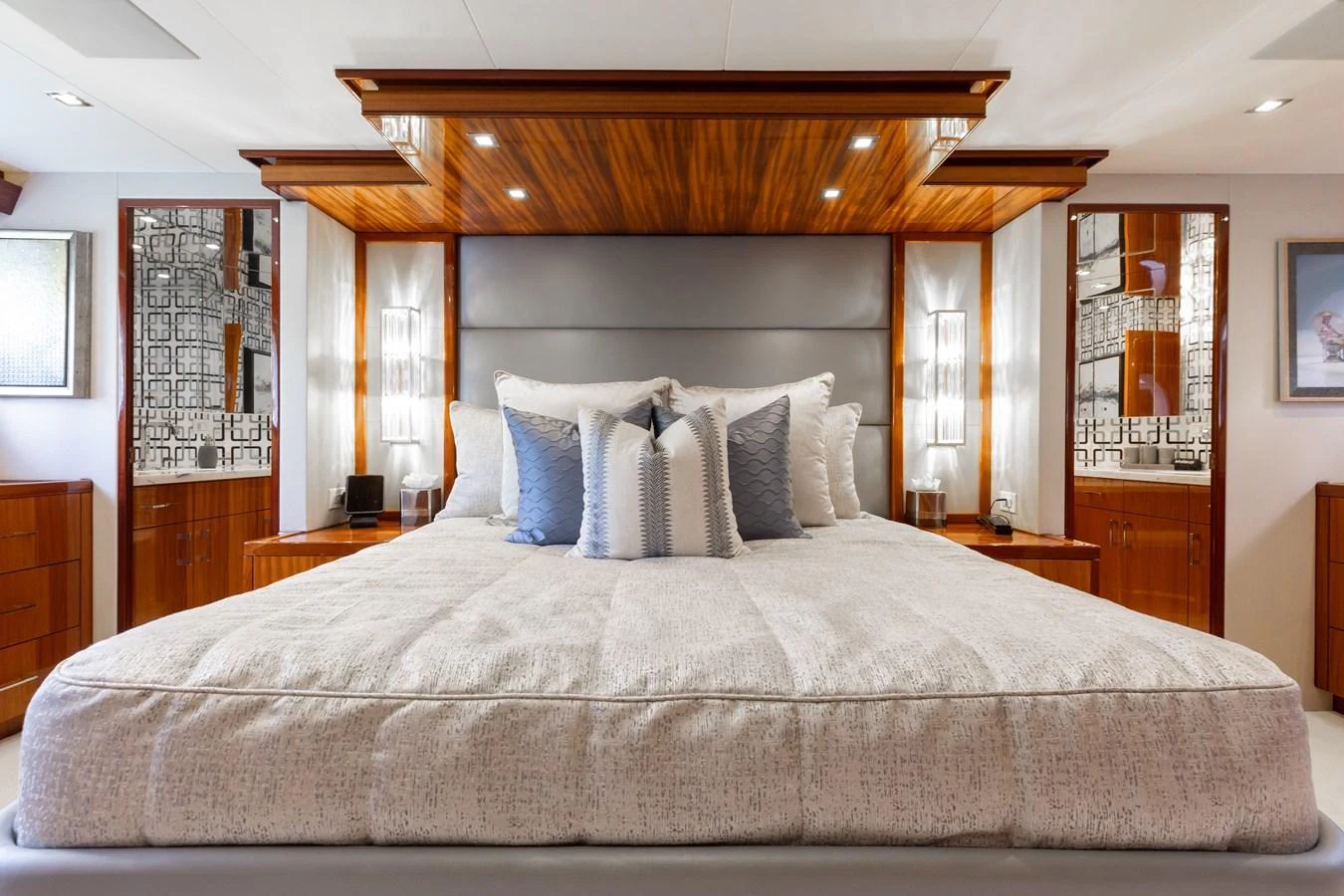 The master stateroom features a luxurious bed with elegant wood finishes and ample lighting. aboard RITZ SEA Yacht for Sale