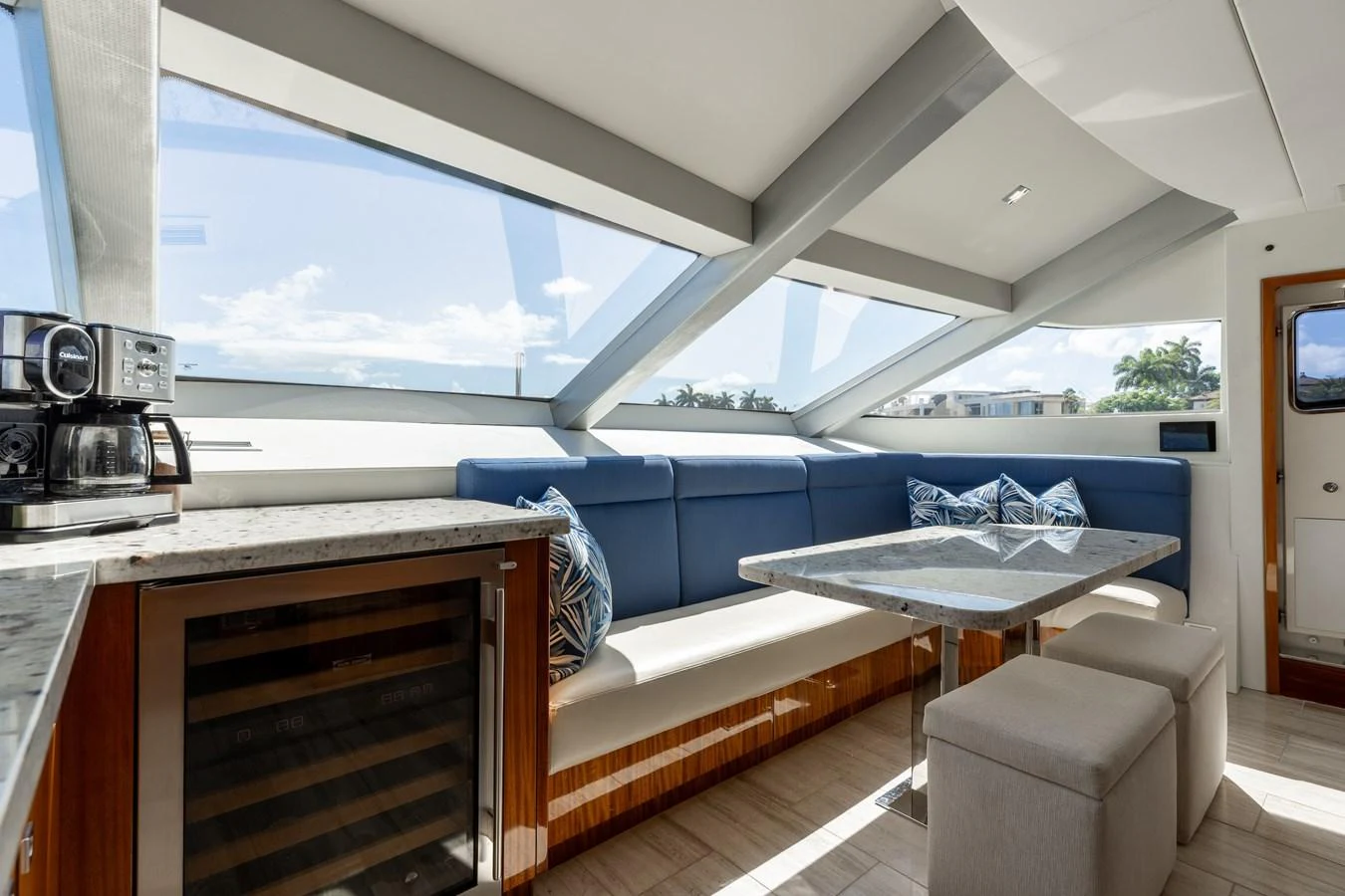 The salon features a cozy seating area with large windows providing ample natural light. aboard RITZ SEA Yacht for Sale