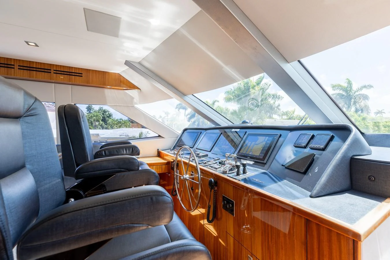The helm station features plush seating and state-of-the-art navigation equipment with expansive windows offering a panoramic view. aboard RITZ SEA Yacht for Sale