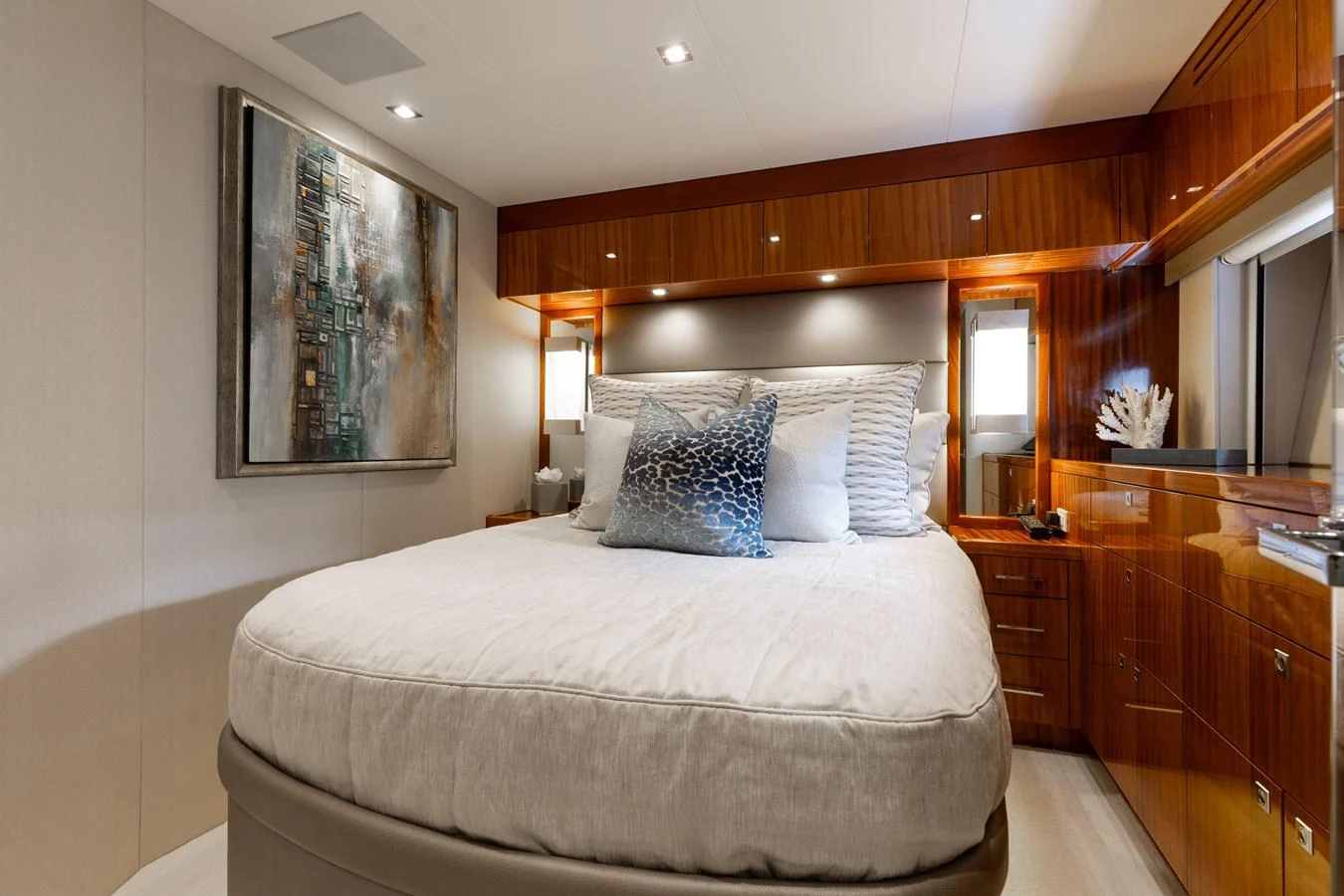 The stateroom features a plush bed with elegant wooden cabinetry and modern decor. aboard RITZ SEA Yacht for Sale
