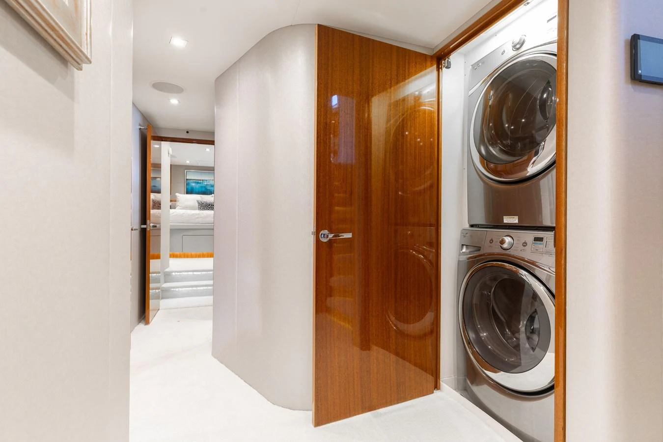 The yacht features a modern laundry area with stacked washer and dryer units. aboard RITZ SEA Yacht for Sale