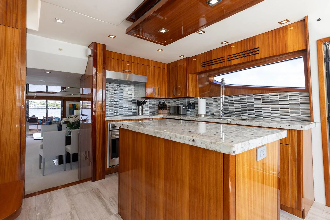 The yacht's galley features sleek wooden cabinetry, modern appliances, and a spacious marble countertop. aboard RITZ SEA Yacht for Sale