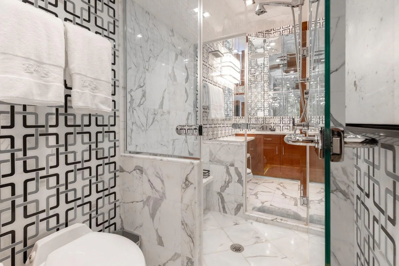 The bathroom features elegant marble surfaces and modern fixtures, creating a luxurious and sophisticated atmosphere. aboard RITZ SEA Yacht for Sale