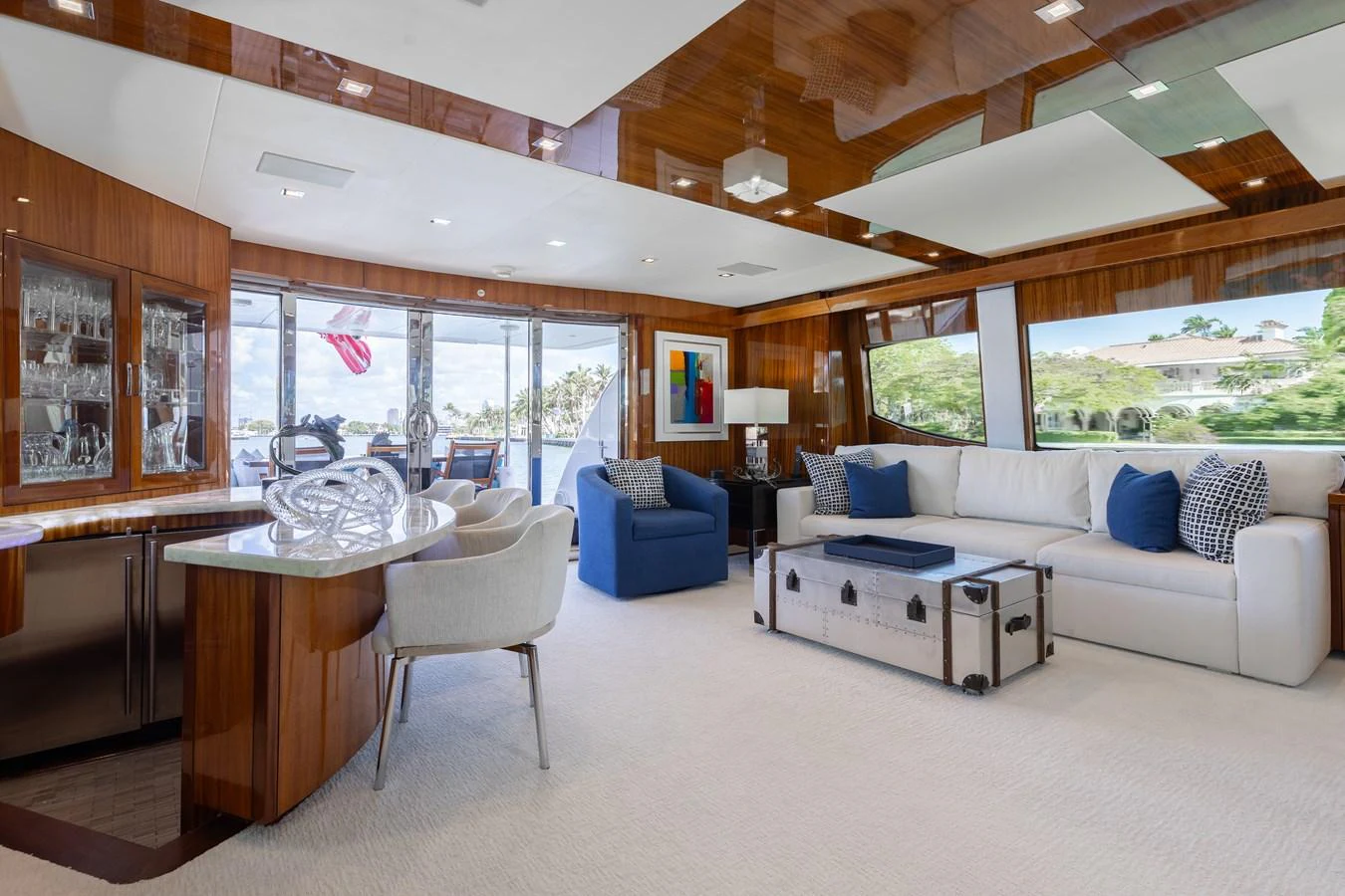 The salon features a spacious and elegantly designed living area with ample seating and large windows offering scenic views. aboard RITZ SEA Yacht for Sale