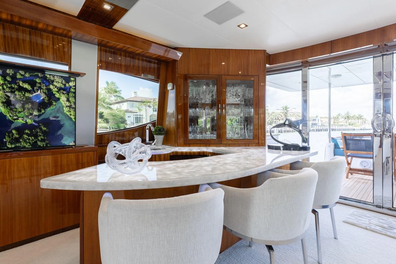The salon features elegant seating, a polished dining table, and large windows offering scenic views. aboard RITZ SEA Yacht for Sale