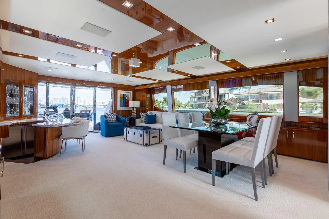 The spacious salon features elegant seating and a dining area with large windows offering panoramic views. aboard RITZ SEA Yacht for Sale