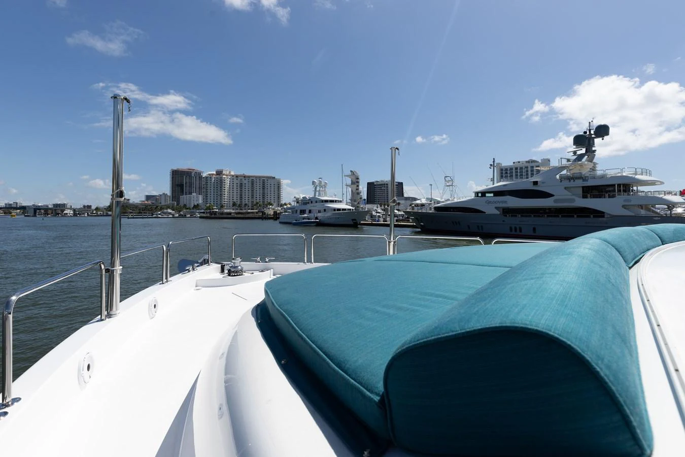 The yacht is docked in a marina with a view of the city skyline in the background. aboard RITZ SEA Yacht for Sale
